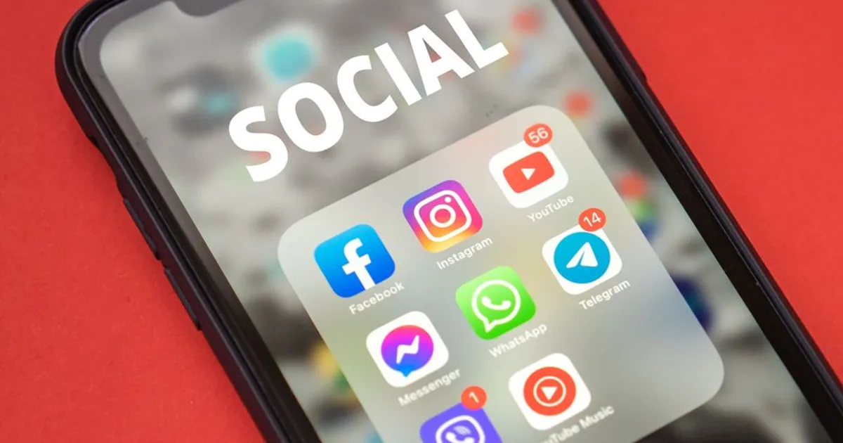 Close-up of a smartphone showing popular social media apps on screen.