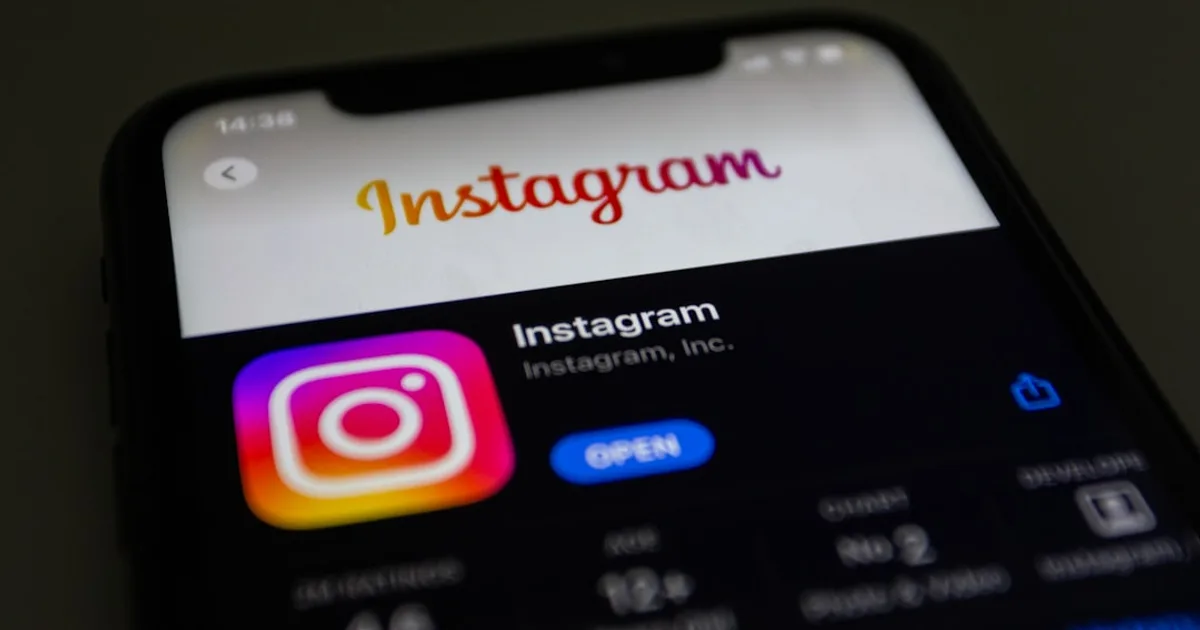 the instagram logo is displayed on an iphone