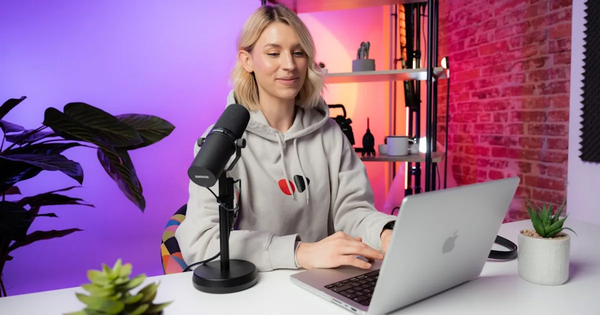 a woman sitting in front of a laptop computer
